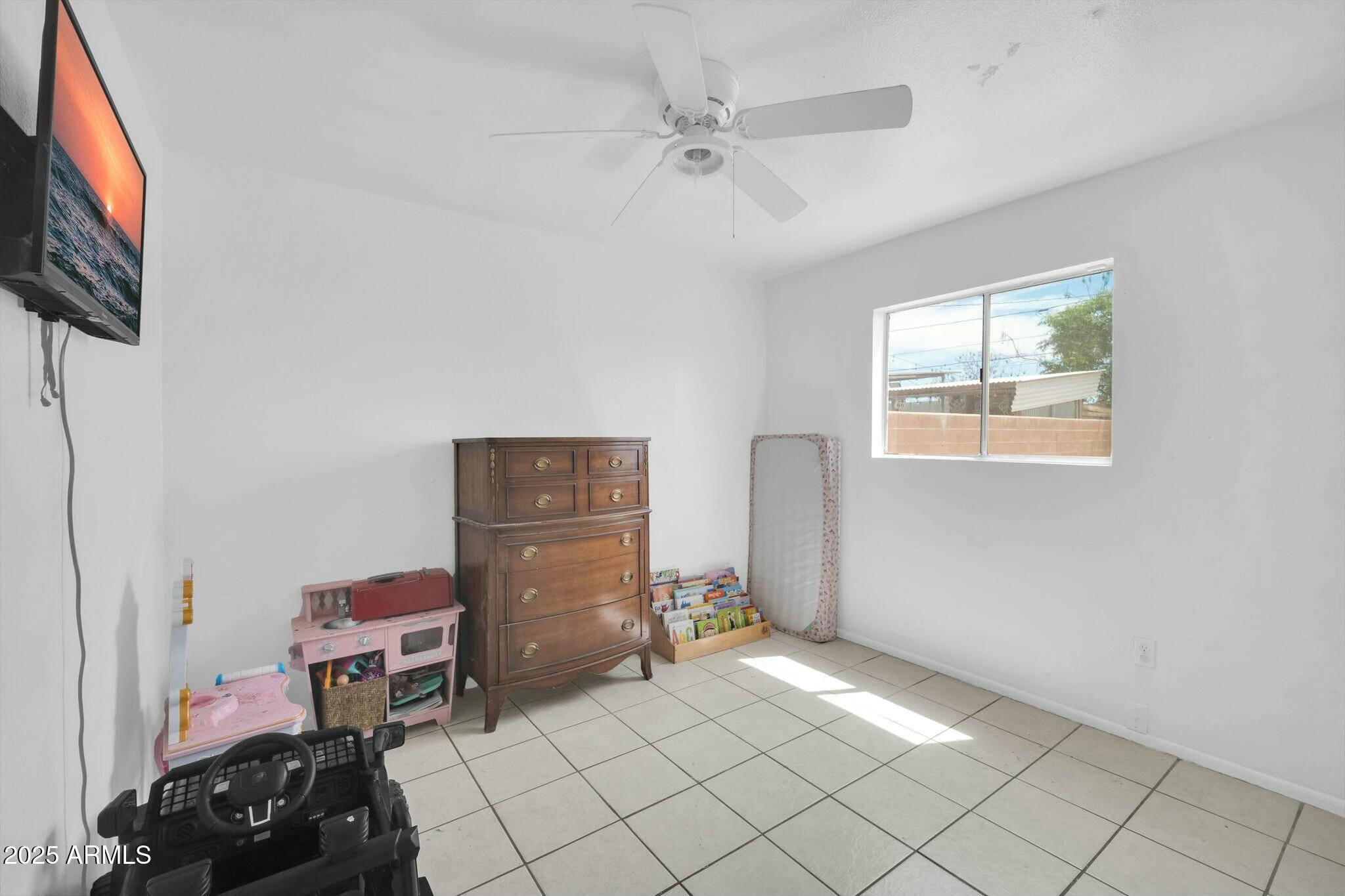 2929 West Granada Road Phoenix, AZ 85009 - Photo 14 of 28 a view of a workspace with furniture and a window