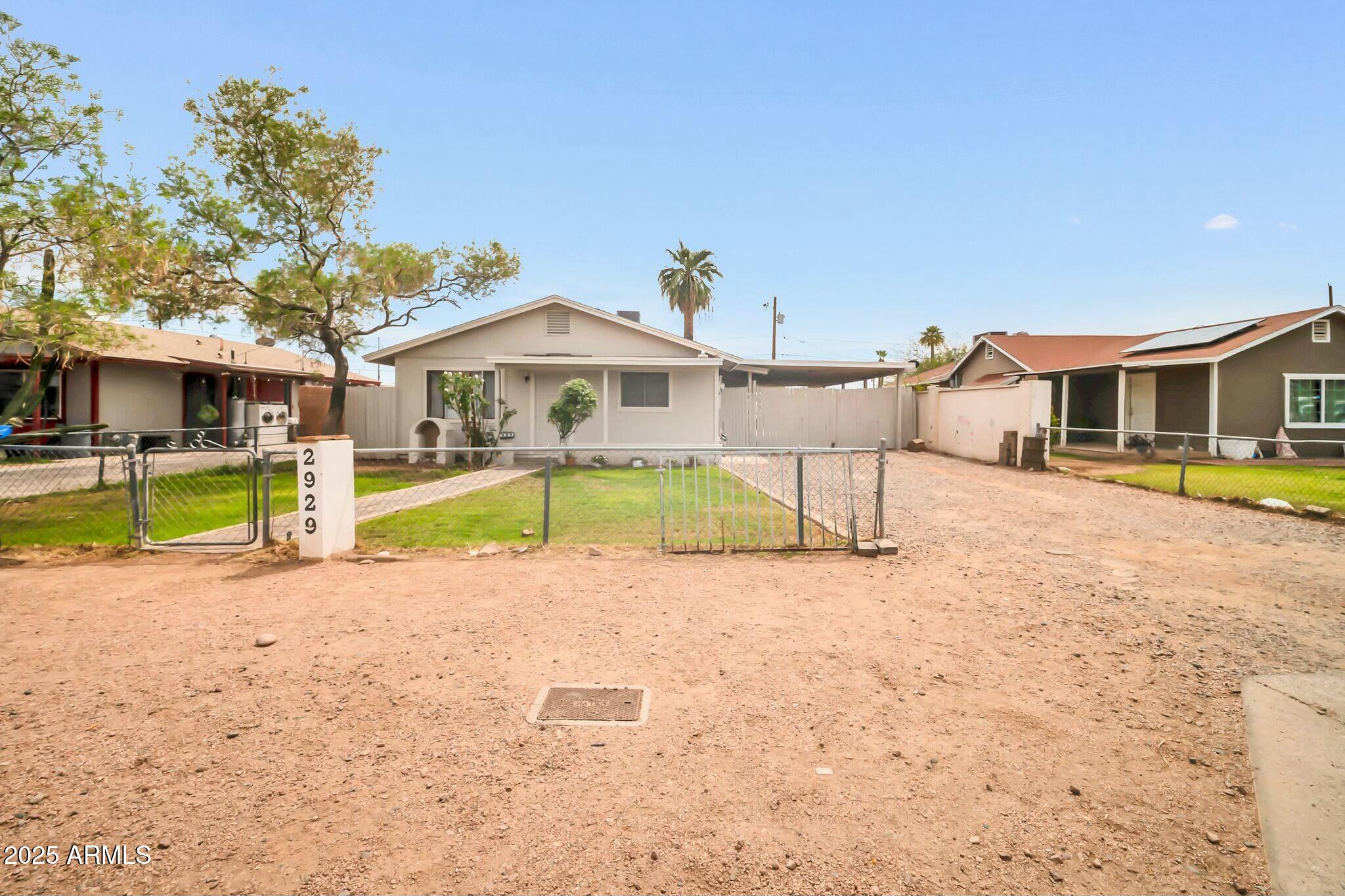 2929 West Granada Road Phoenix, AZ 85009 - Photo 2 of 28 a view of a house with a yard and sitting area
