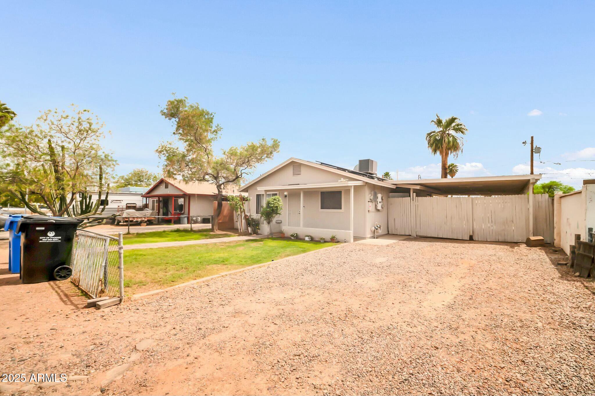 2929 West Granada Road Phoenix, AZ 85009 - Photo 3 of 28 a view of a house with a yard and sitting area