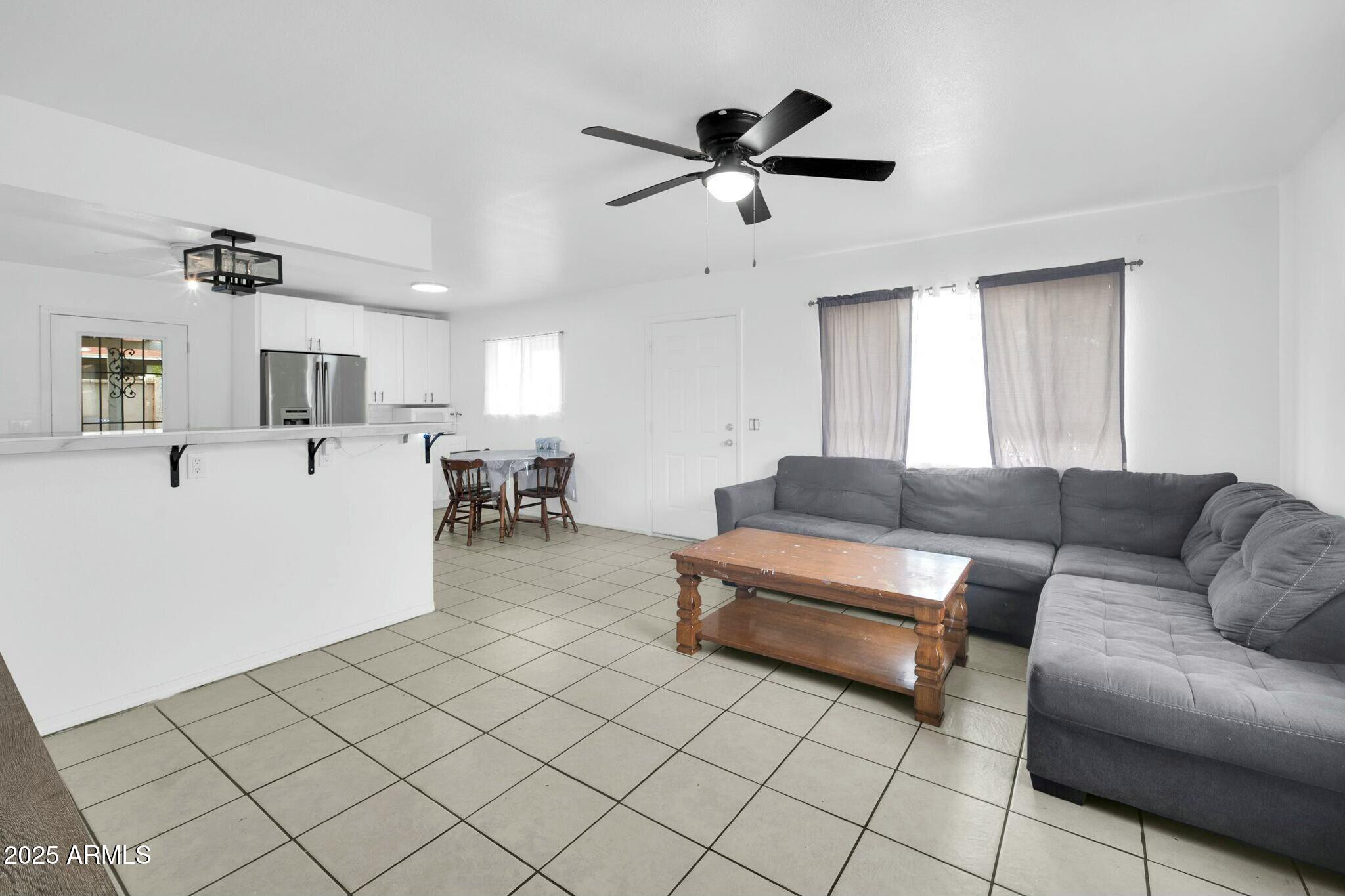 2929 West Granada Road Phoenix, AZ 85009 - Photo 5 of 28 a living room with furniture and a wooden floor