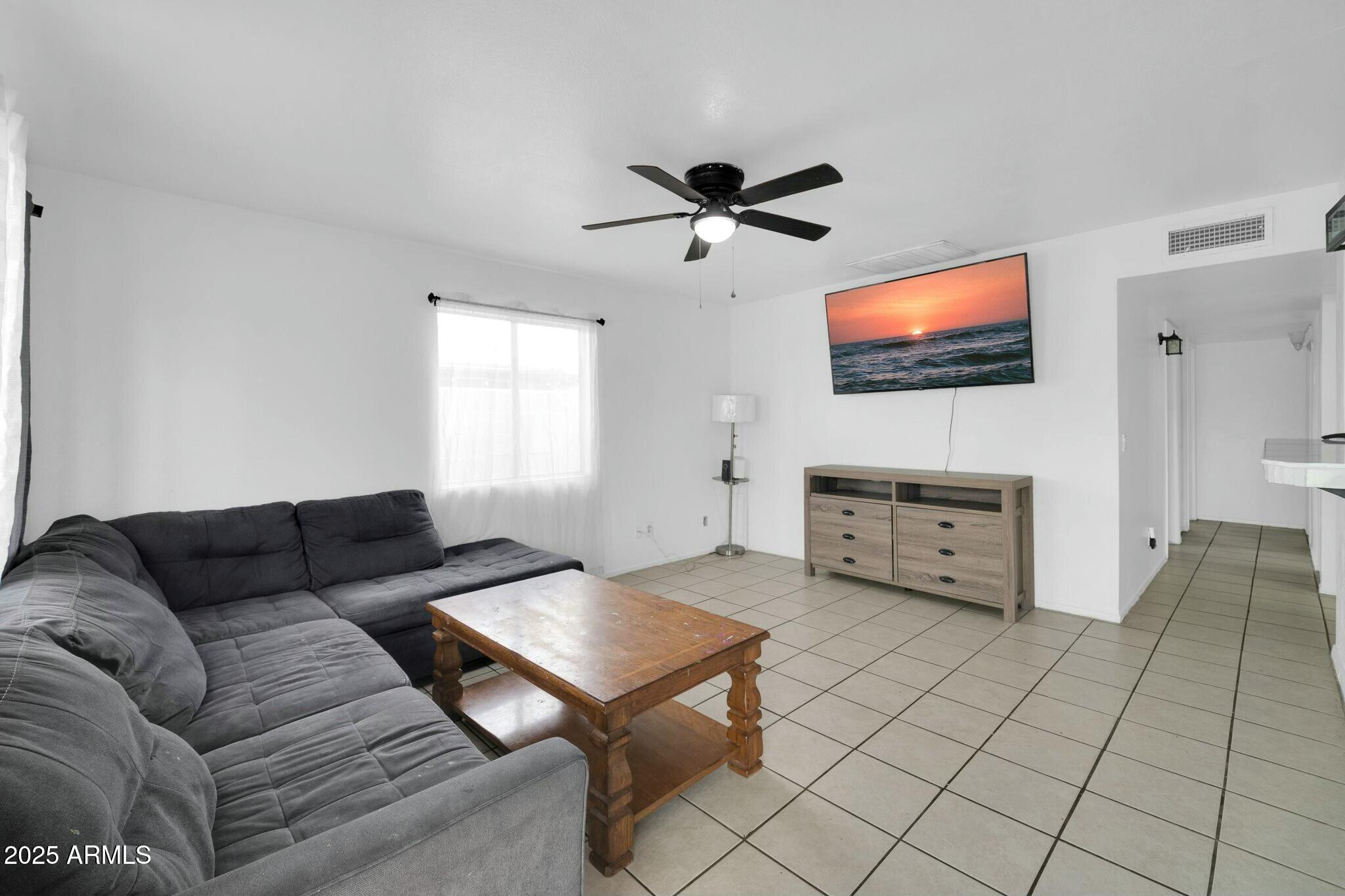 2929 West Granada Road Phoenix, AZ 85009 - Photo 6 of 28 a living room with furniture and a flat screen tv