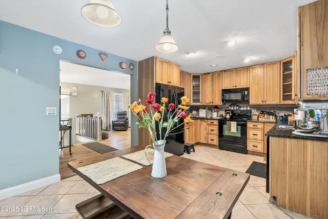a kitchen with a refrigerator and a stove