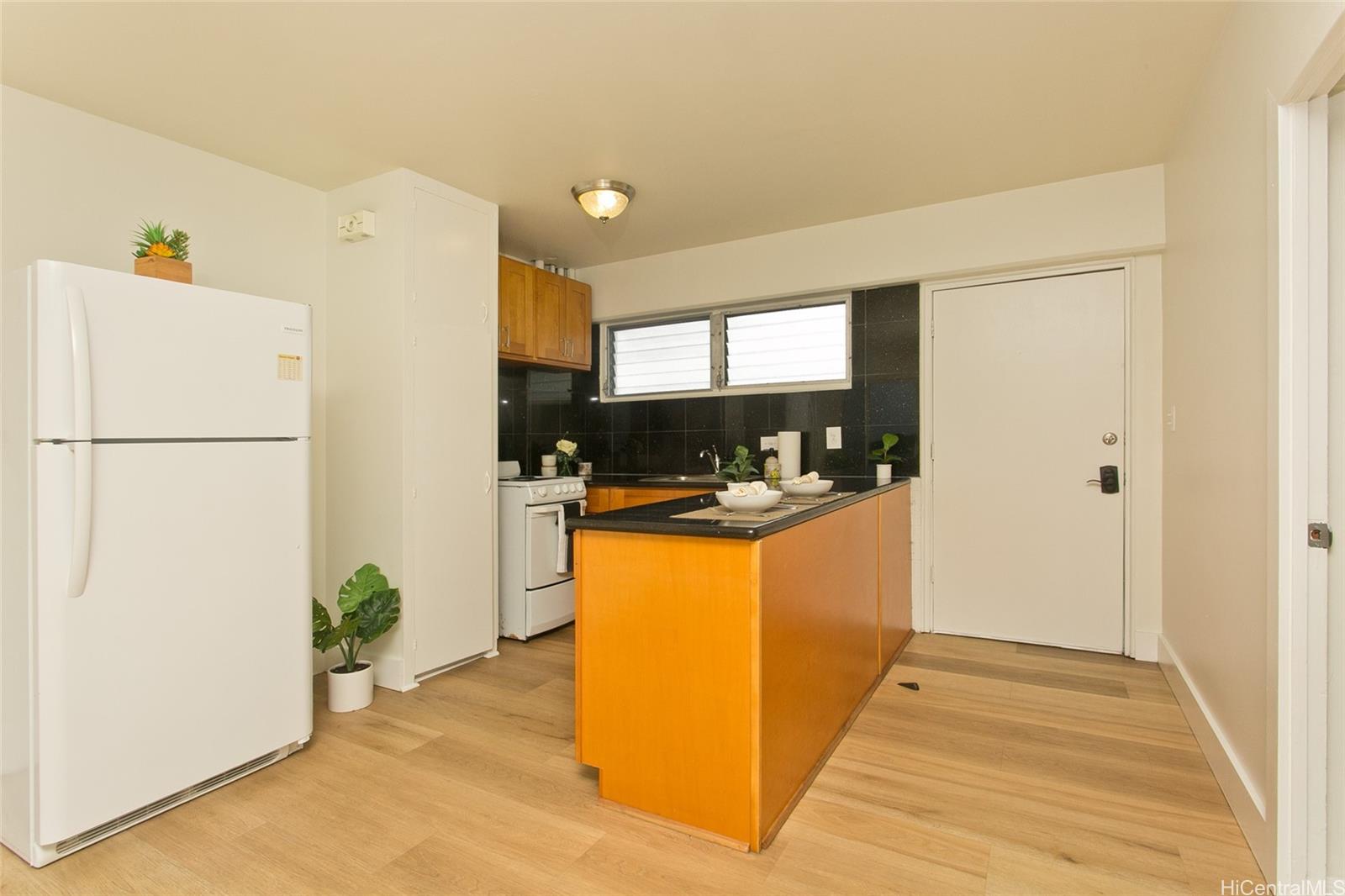 909 University Avenue, Unit 211 Honolulu, HI 96826 - Photo 5 of 10 a kitchen with a refrigerator and a stove