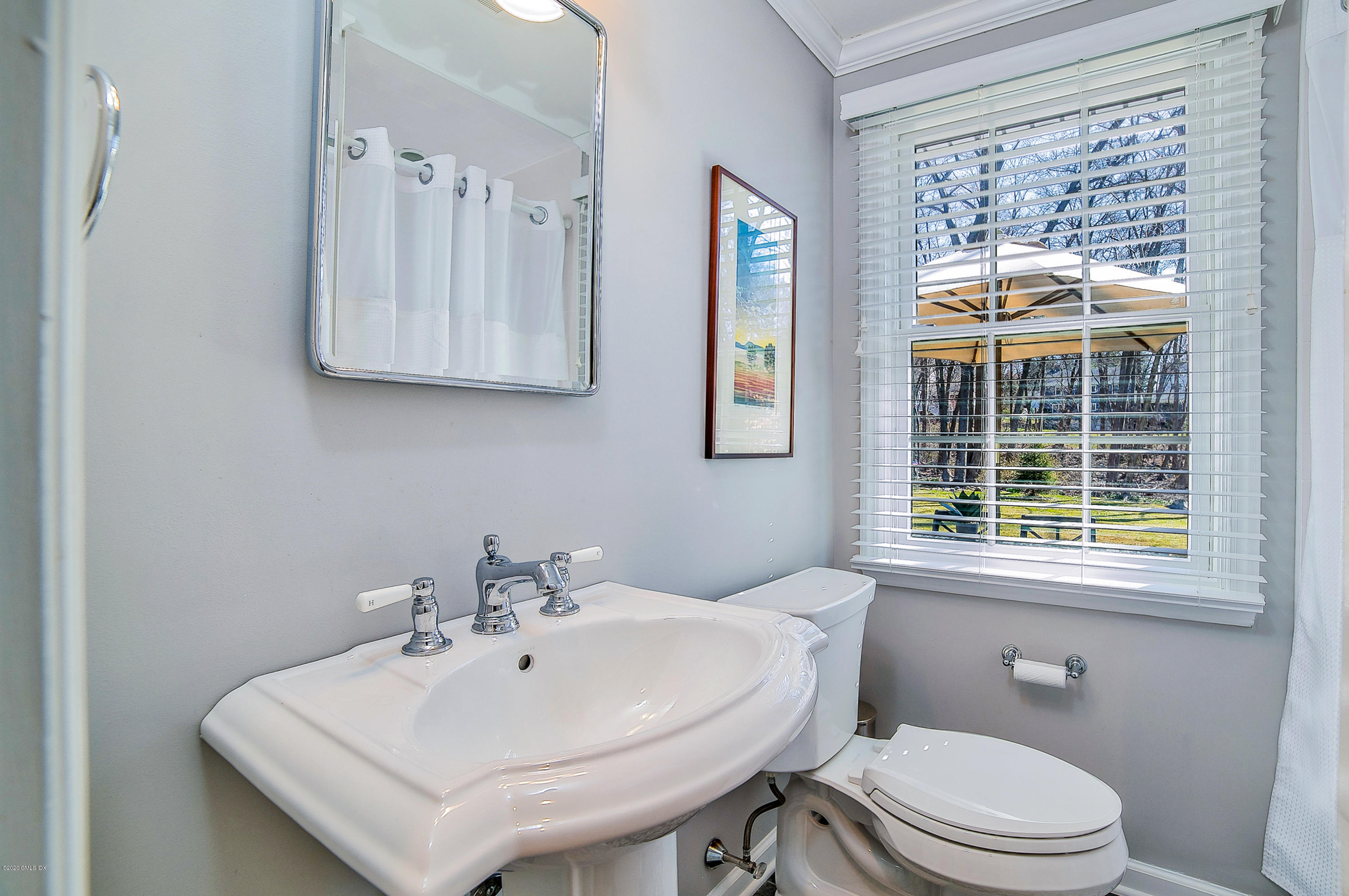 73 Malvern Road Stamford, CT 06905 - Photo 13 of 25 a bathroom with a sink a toilet and a window