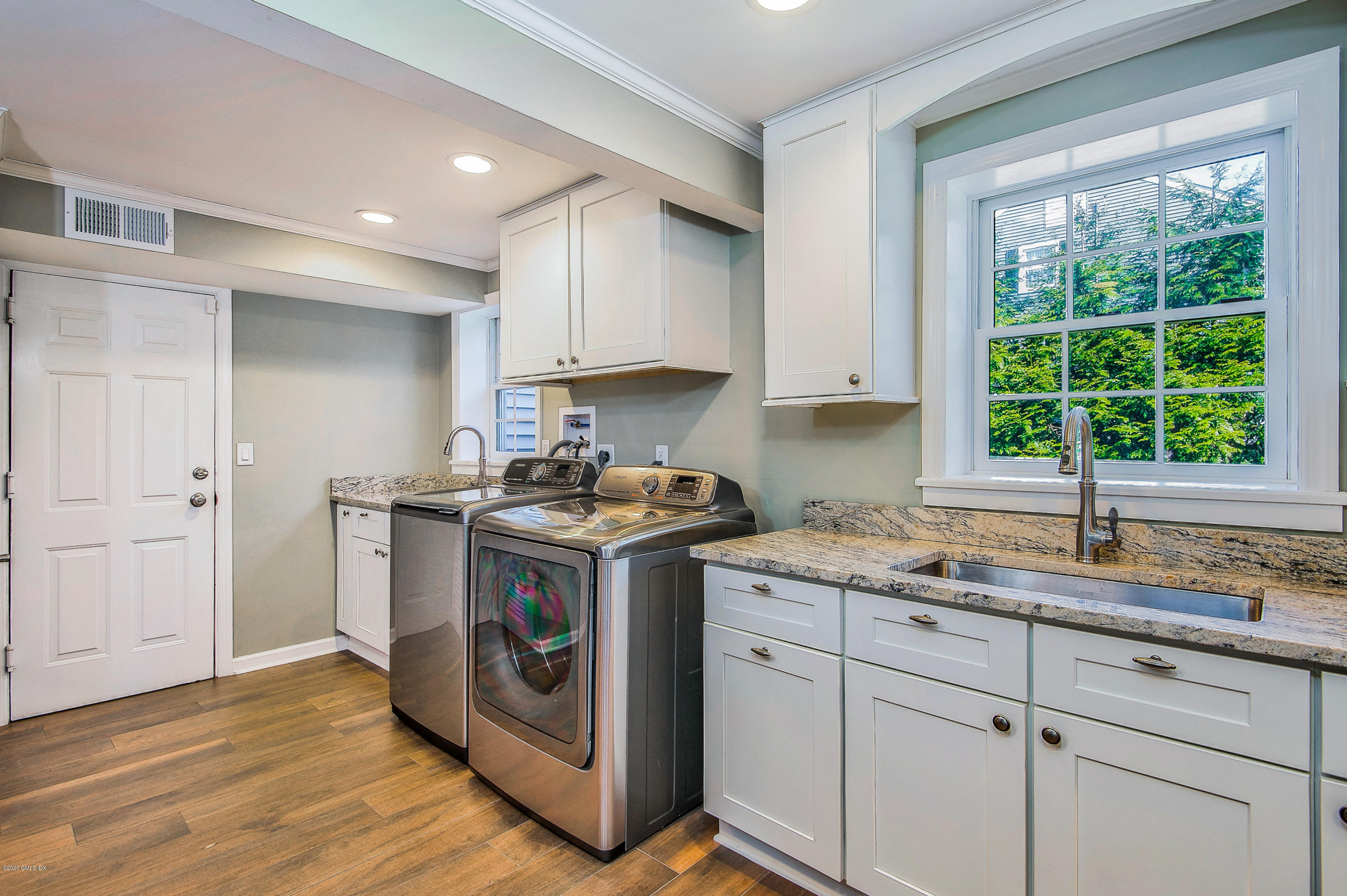 73 Malvern Road Stamford, CT 06905 - Photo 15 of 25 a kitchen with a sink stove and cabinets