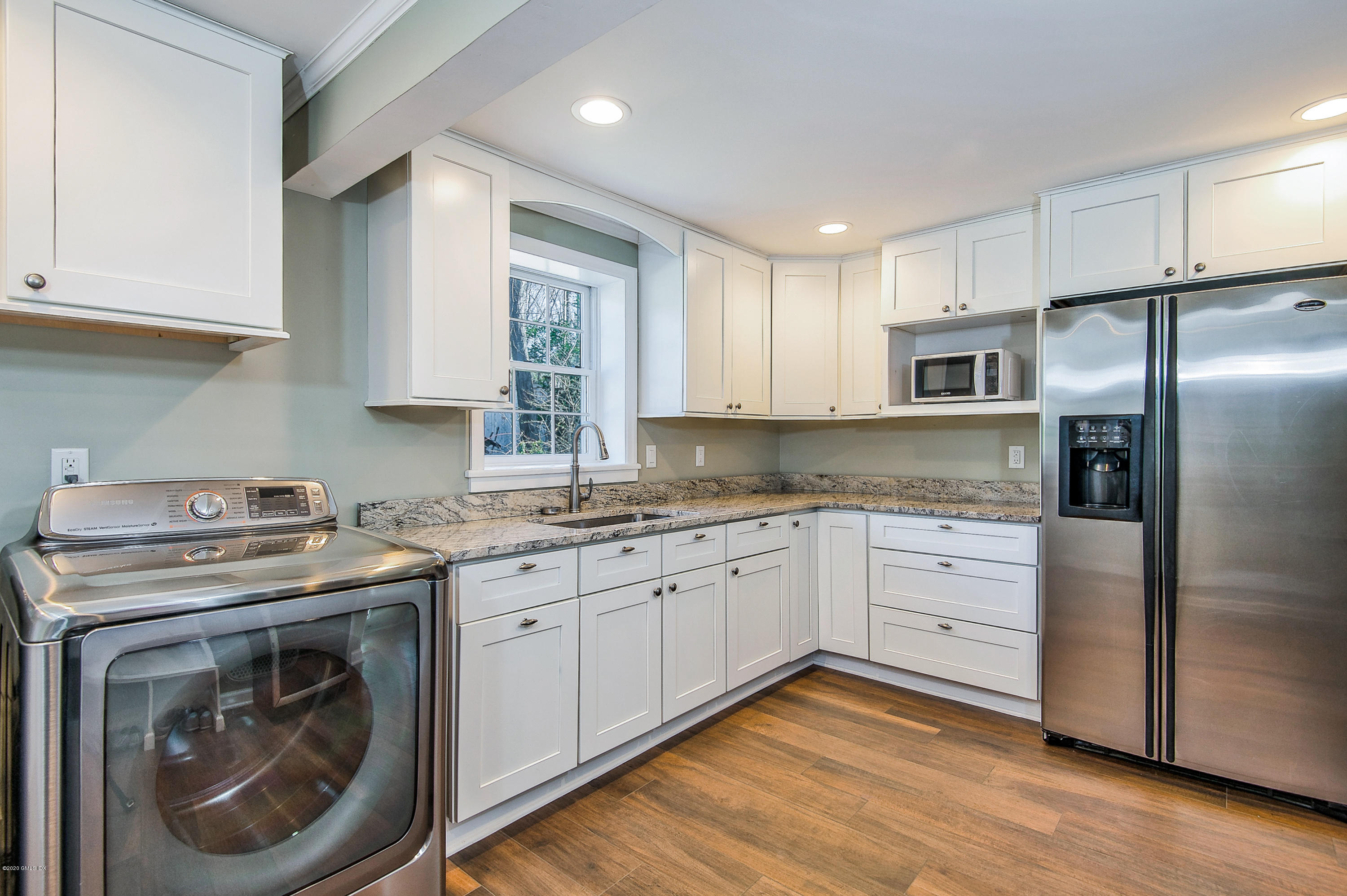 73 Malvern Road Stamford, CT 06905 - Photo 16 of 25 a kitchen with stainless steel appliances granite countertop a stove a sink and a refrigerator
