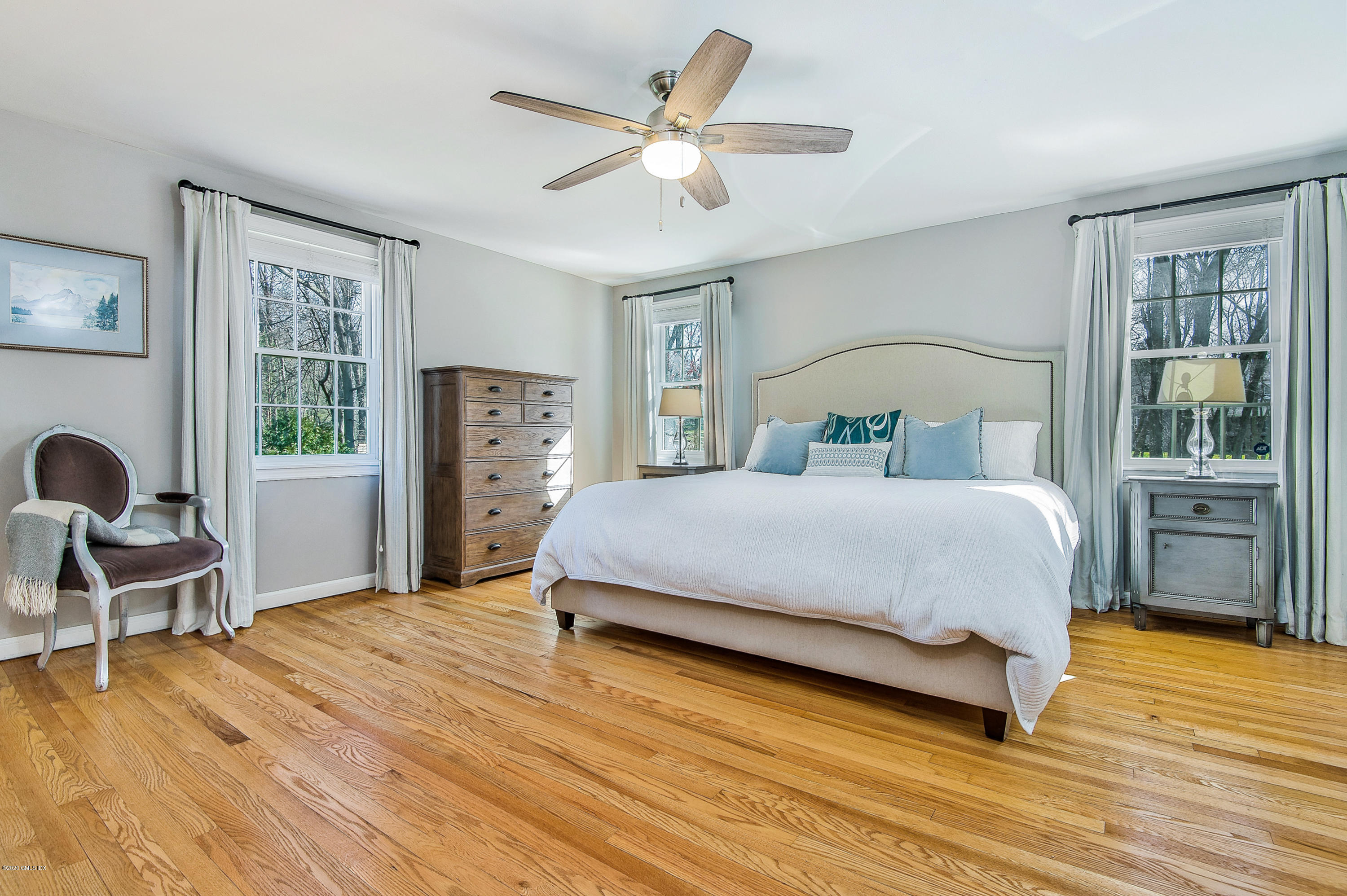 73 Malvern Road Stamford, CT 06905 - Photo 5 of 25 a bedroom with a large bed and wooden floor