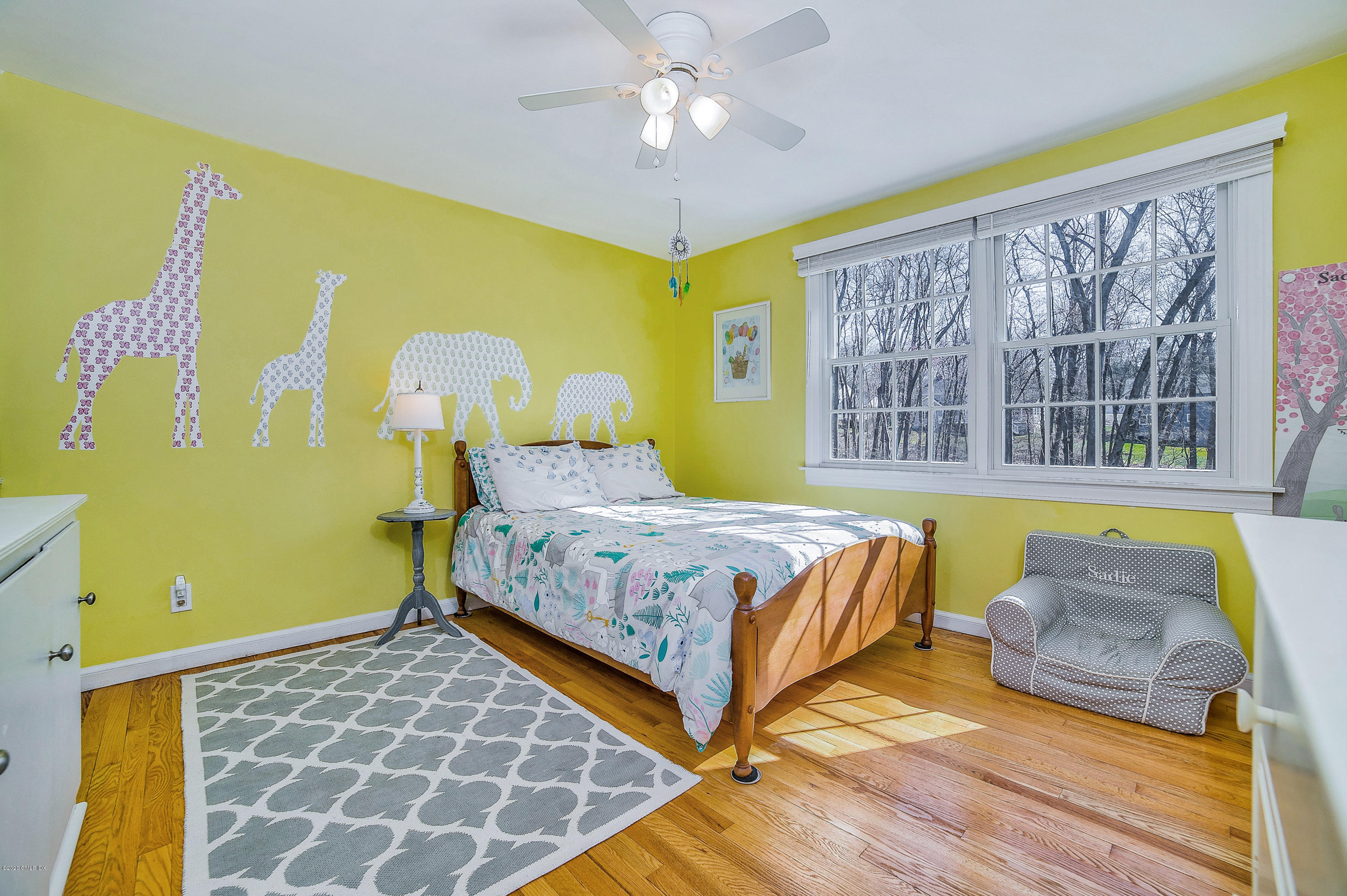 73 Malvern Road Stamford, CT 06905 - Photo 7 of 25 a bedroom with a bed and a chandelier