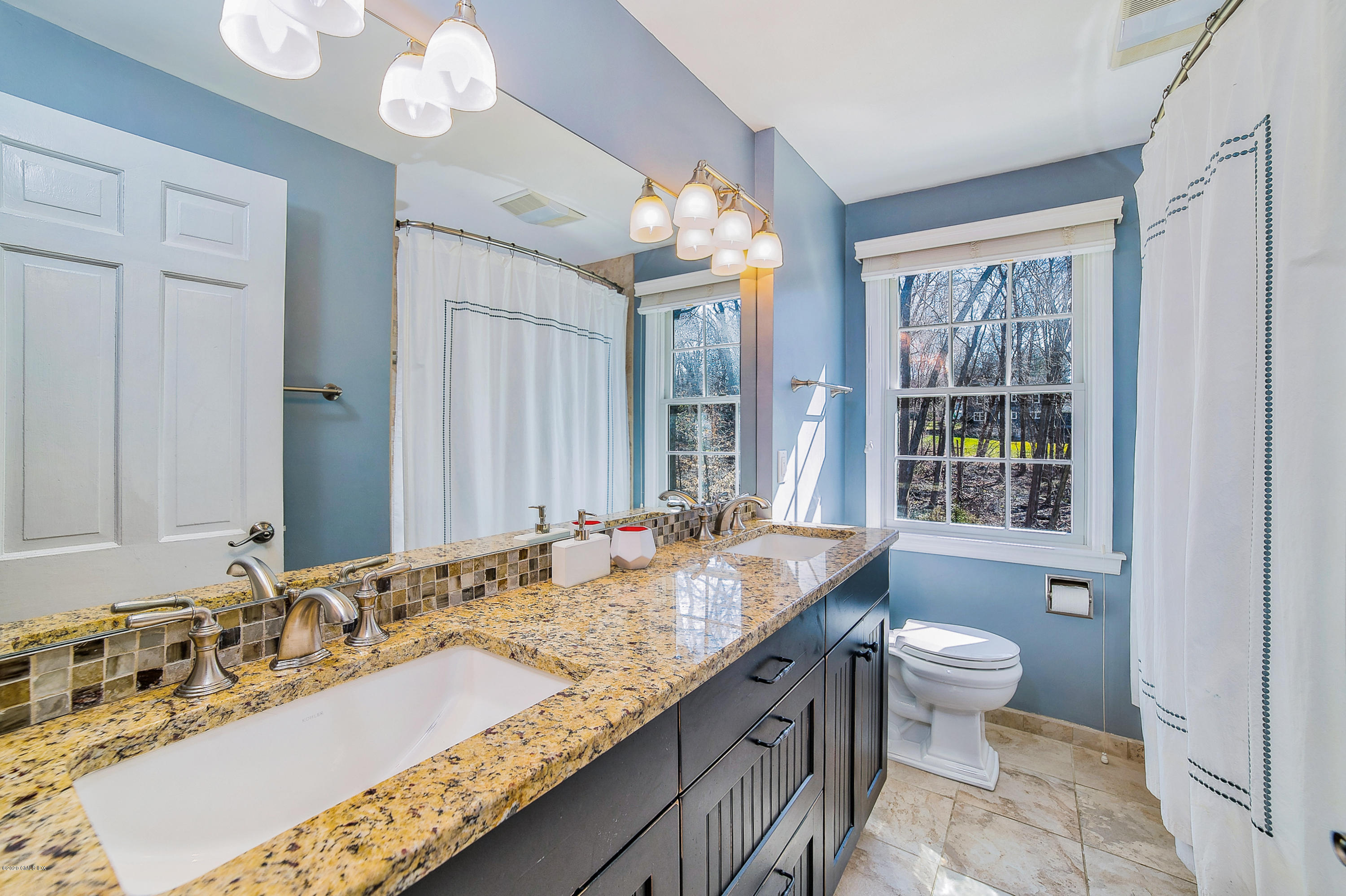 73 Malvern Road Stamford, CT 06905 - Photo 8 of 25 a bathroom with a granite countertop double vanity sink a mirror and a bathtub