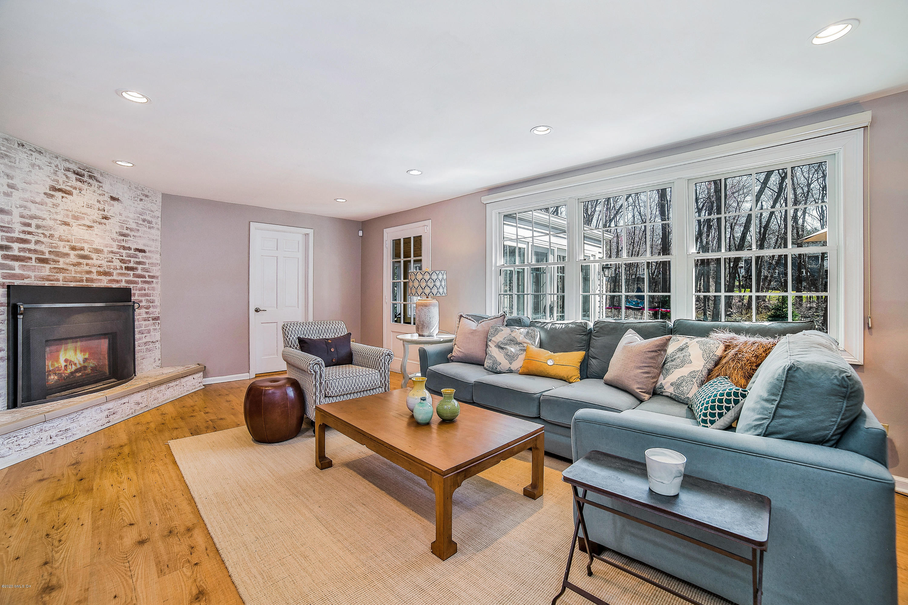 73 Malvern Road Stamford, CT 06905 - Photo 10 of 25 a living room with furniture and a fireplace