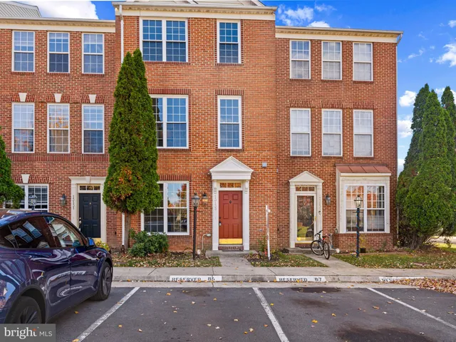 a couple of cars parked in front of a building
