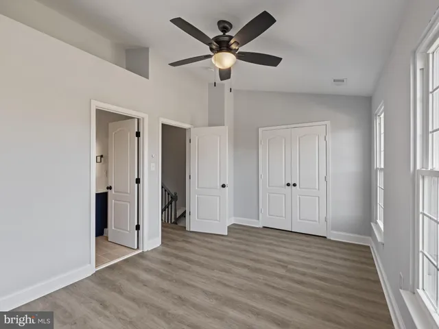 a view of an empty room and wooden floor