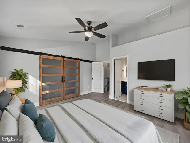 a bedroom with a bed and a flat screen tv