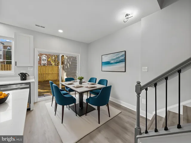 a view of a dining room with furniture and a window