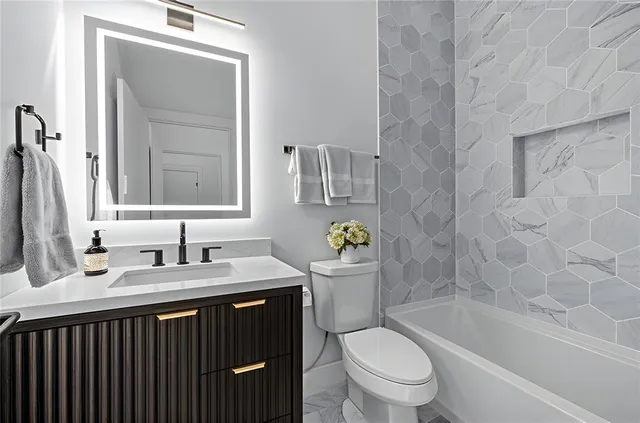 a bathroom with a sink a toilet and a bathtub