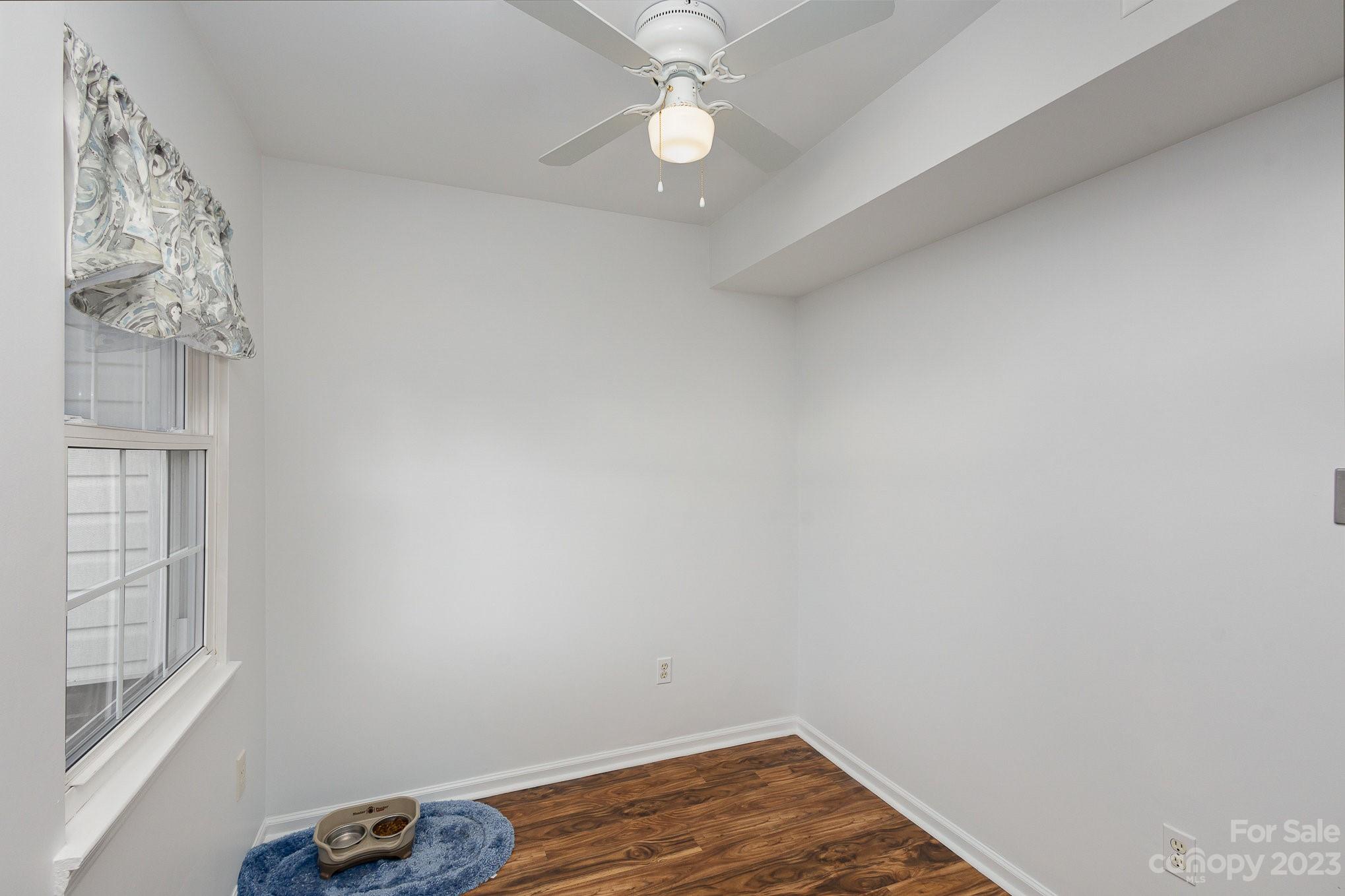10927 Park Road Charlotte, NC 28226 - Photo 14 of 28 an empty room with a window and wooden floor