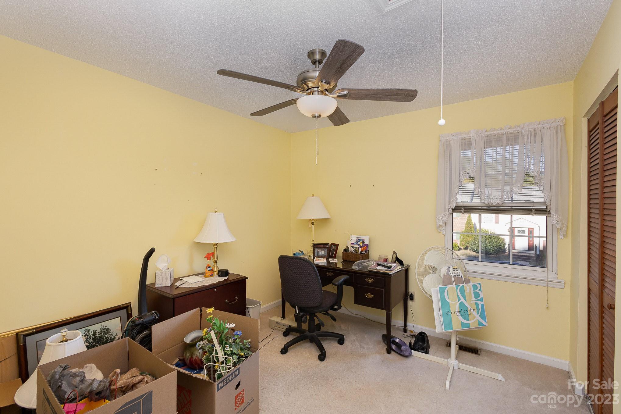 10927 Park Road Charlotte, NC 28226 - Photo 23 of 28 a view of a workspace with furniture and a window