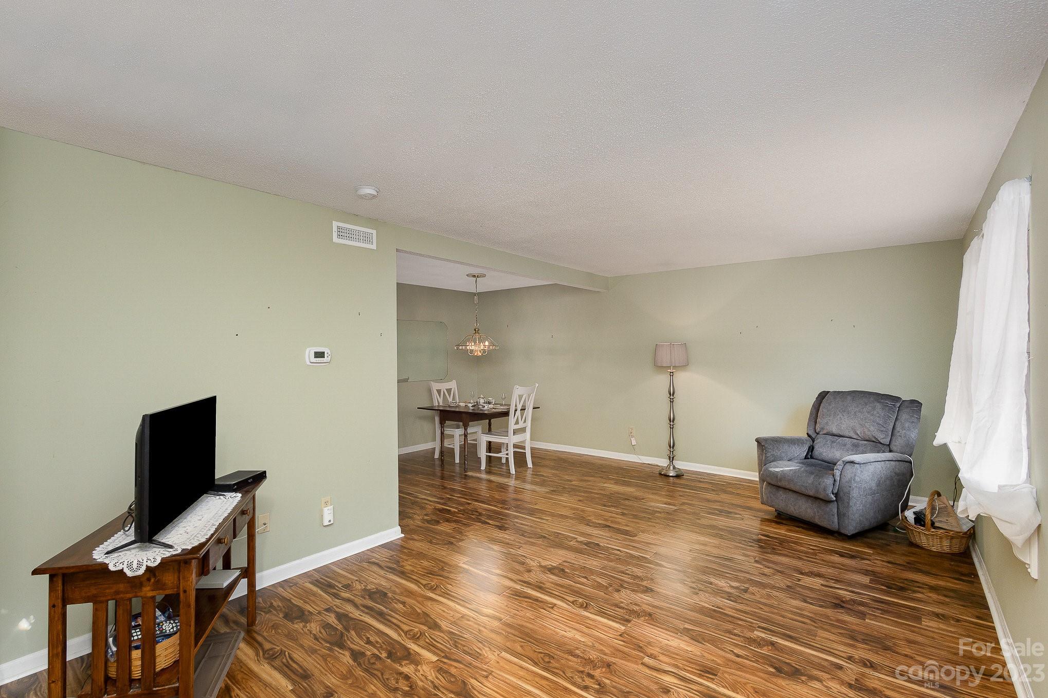 10927 Park Road Charlotte, NC 28226 - Photo 3 of 28 a view of a workspace with furniture and a flat screen tv