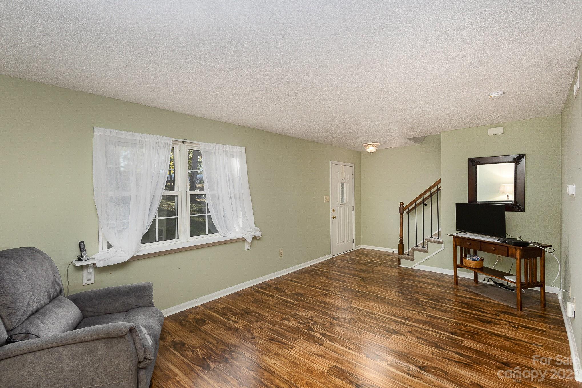 10927 Park Road Charlotte, NC 28226 - Photo 4 of 28 a bedroom with furniture and a window