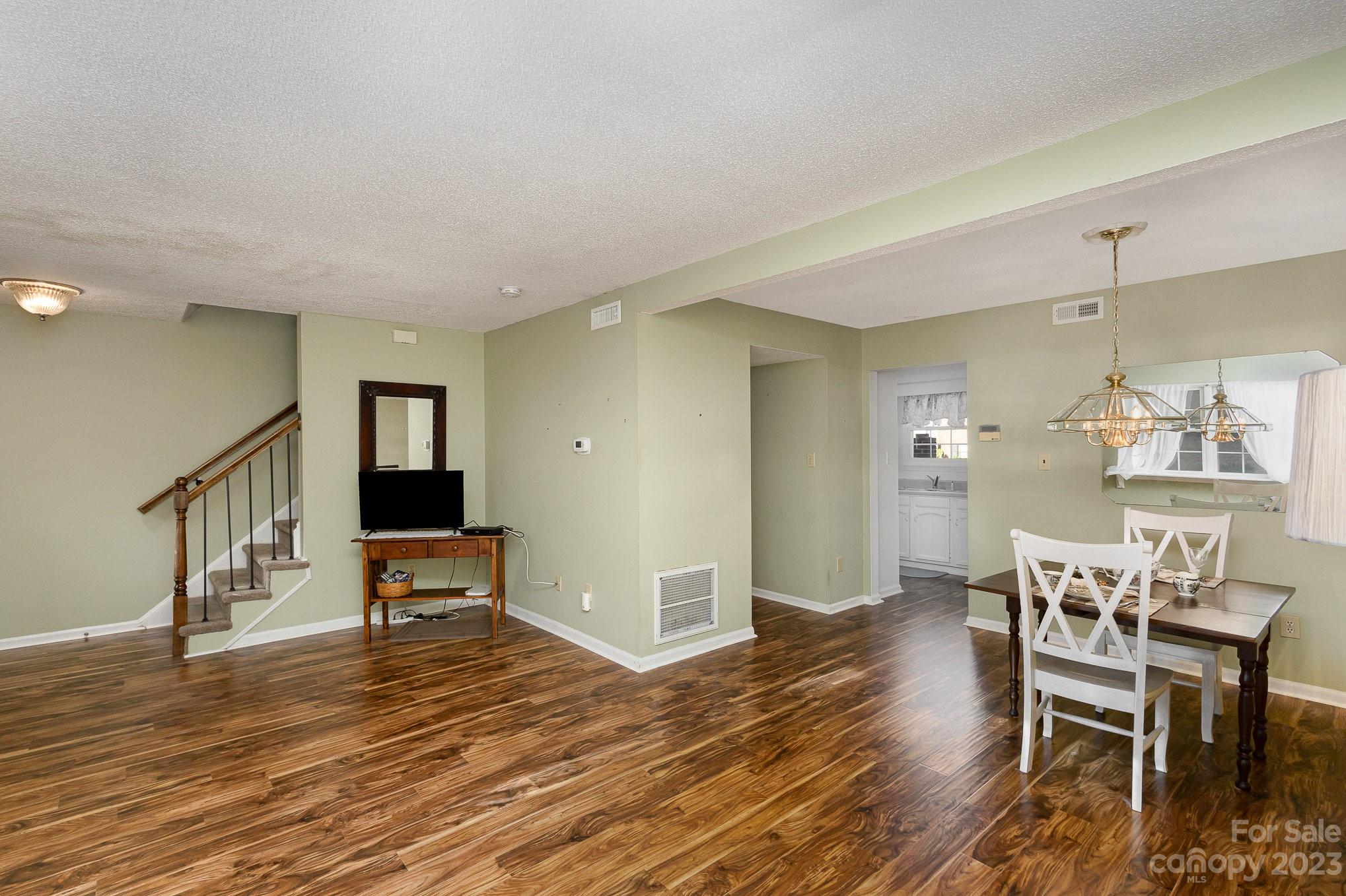 10927 Park Road Charlotte, NC 28226 - Photo 5 of 28 a view of a dining room with furniture and wooden floor