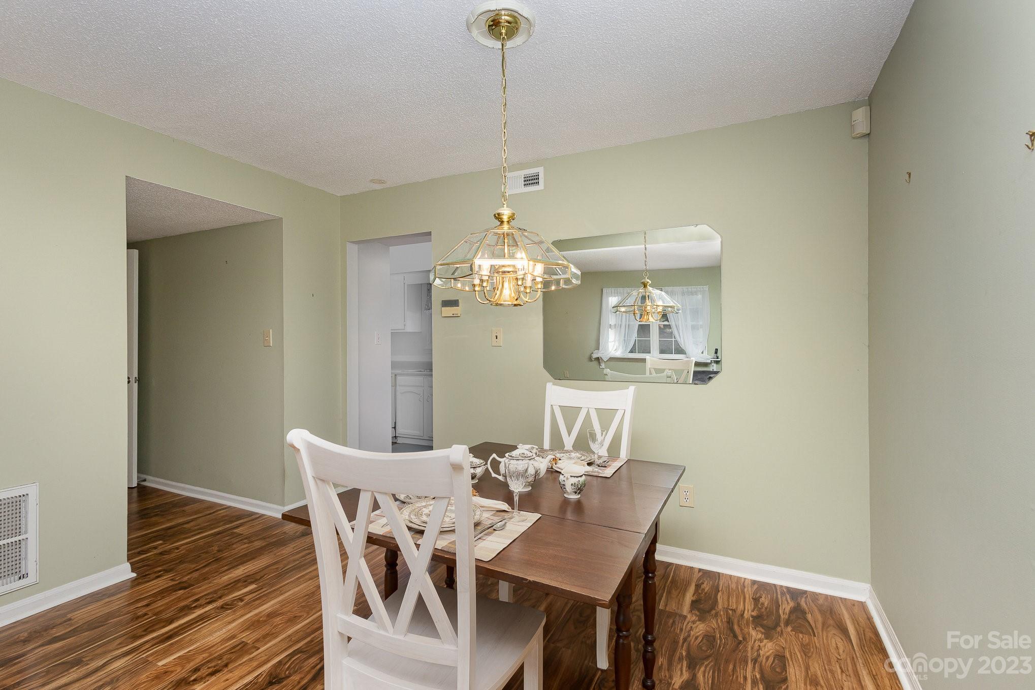 10927 Park Road Charlotte, NC 28226 - Photo 6 of 28 a view of a dining room with furniture and wooden floor