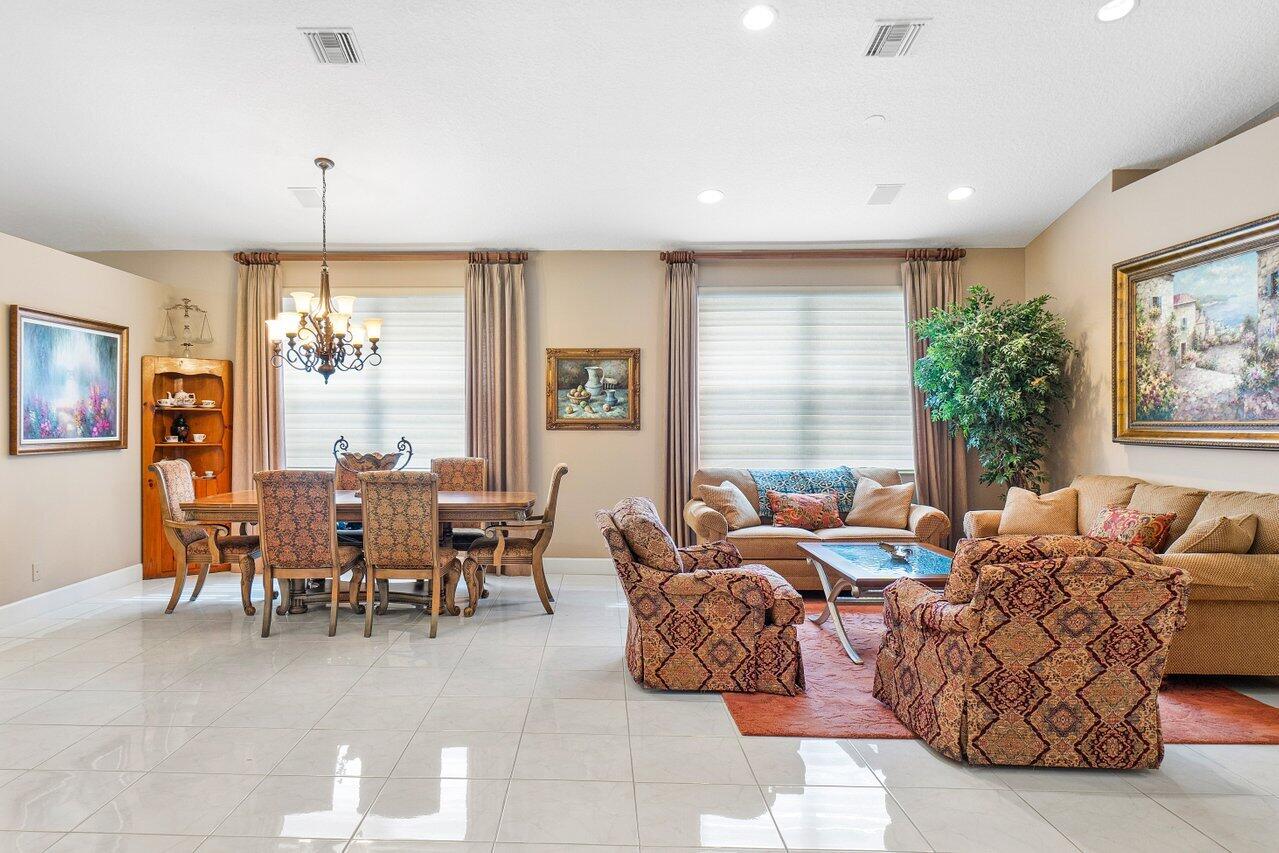 9031 Long Lake Palm Drive Boca Raton, FL 33496 - Photo 11 of 53 a living room with furniture a chandelier and a window