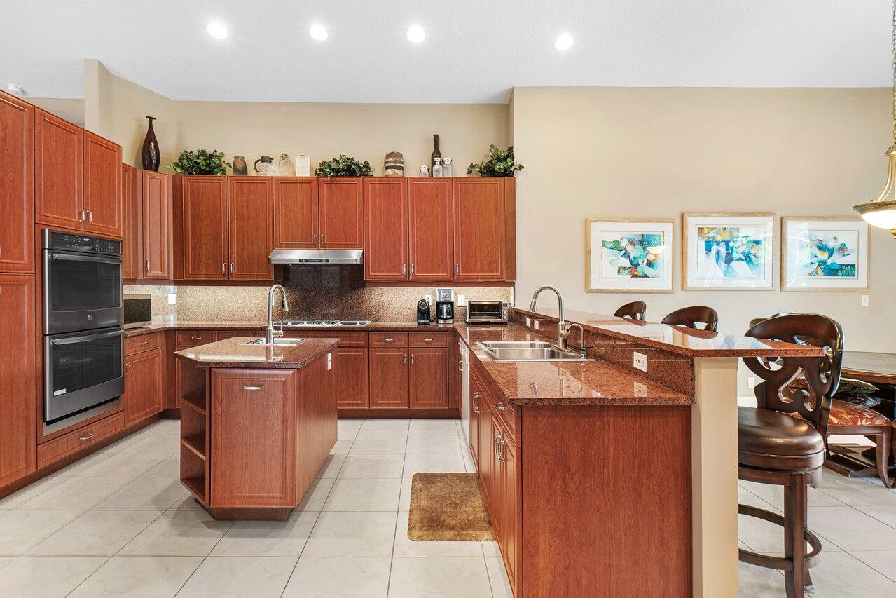 9031 Long Lake Palm Drive Boca Raton, FL 33496 - Photo 12 of 53 a kitchen with stainless steel appliances granite countertop a stove a sink dishwasher and a refrigerator