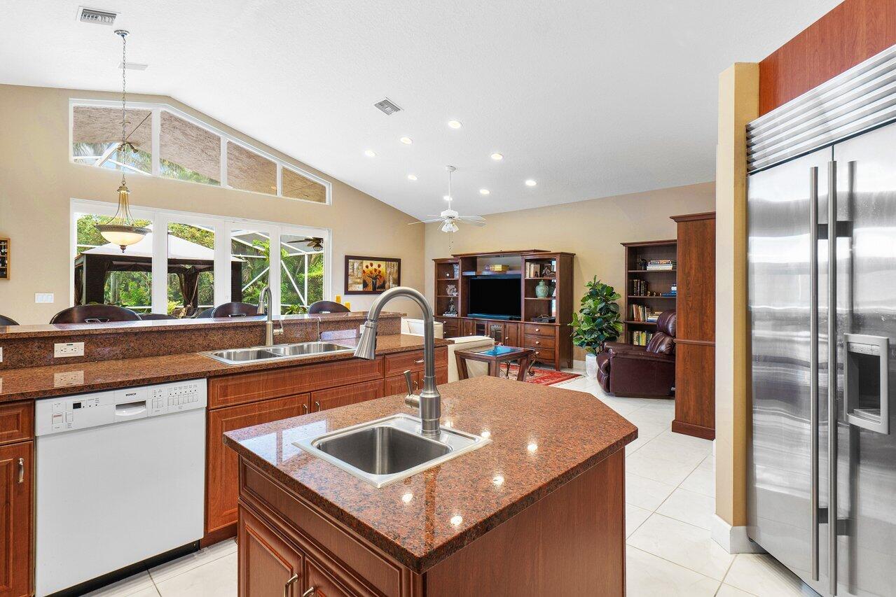 9031 Long Lake Palm Drive Boca Raton, FL 33496 - Photo 15 of 53 a kitchen with stainless steel appliances a sink a microwave a refrigerator and wooden cabinets