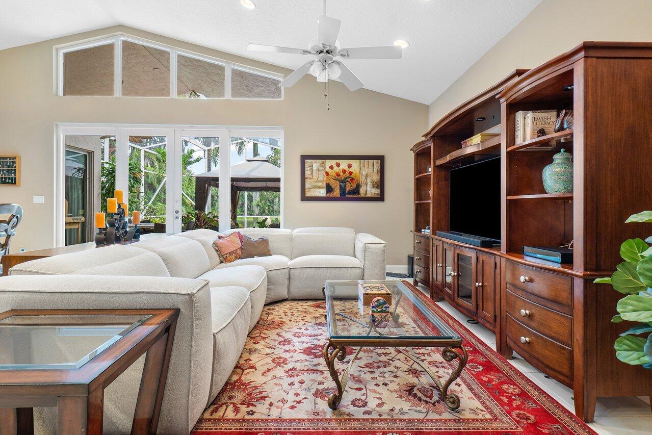 9031 Long Lake Palm Drive Boca Raton, FL 33496 - Photo 17 of 53 a living room with furniture a flat screen tv and a rug