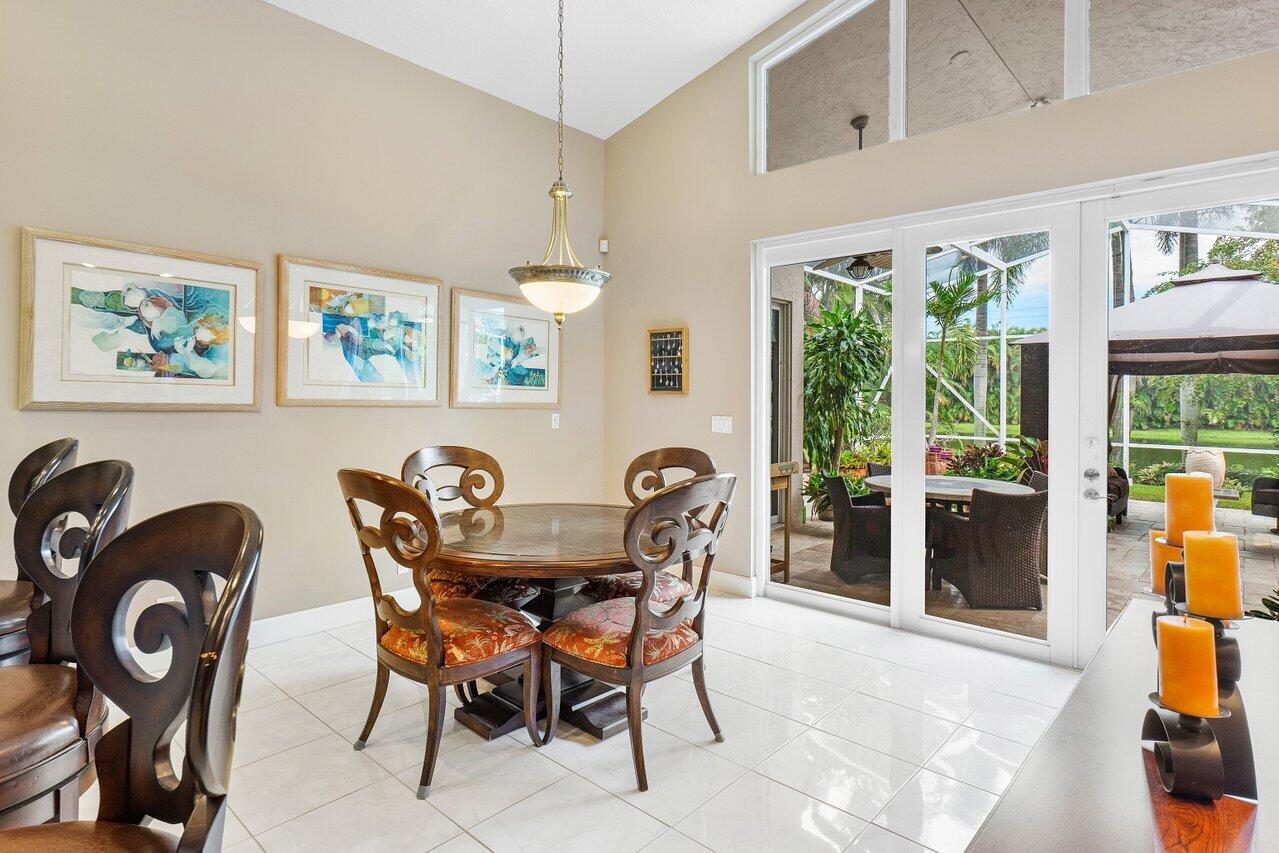 9031 Long Lake Palm Drive Boca Raton, FL 33496 - Photo 18 of 53 a view of a dining room with furniture window and outside view