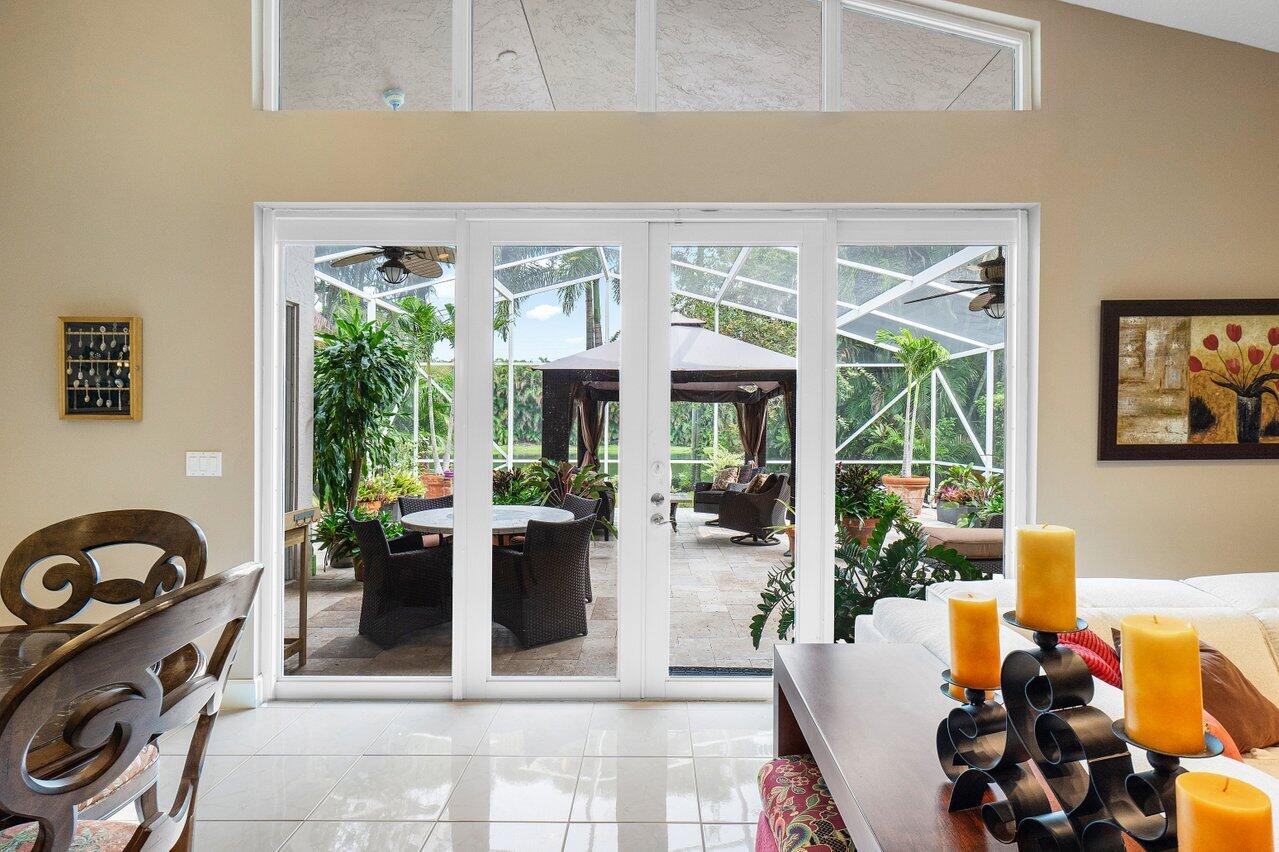 9031 Long Lake Palm Drive Boca Raton, FL 33496 - Photo 19 of 53 a view of a chairs and table in a patio