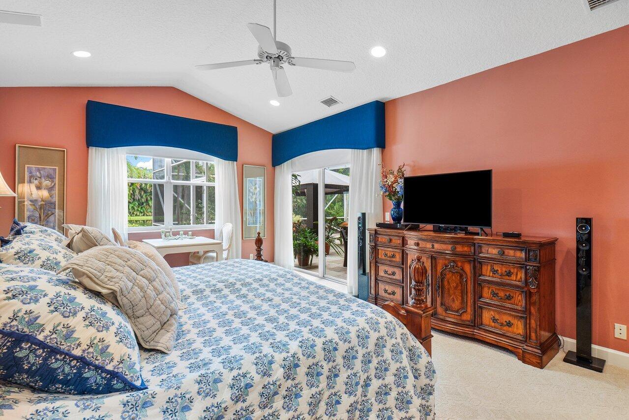 9031 Long Lake Palm Drive Boca Raton, FL 33496 - Photo 23 of 53 a bedroom with a bed and a flat screen tv