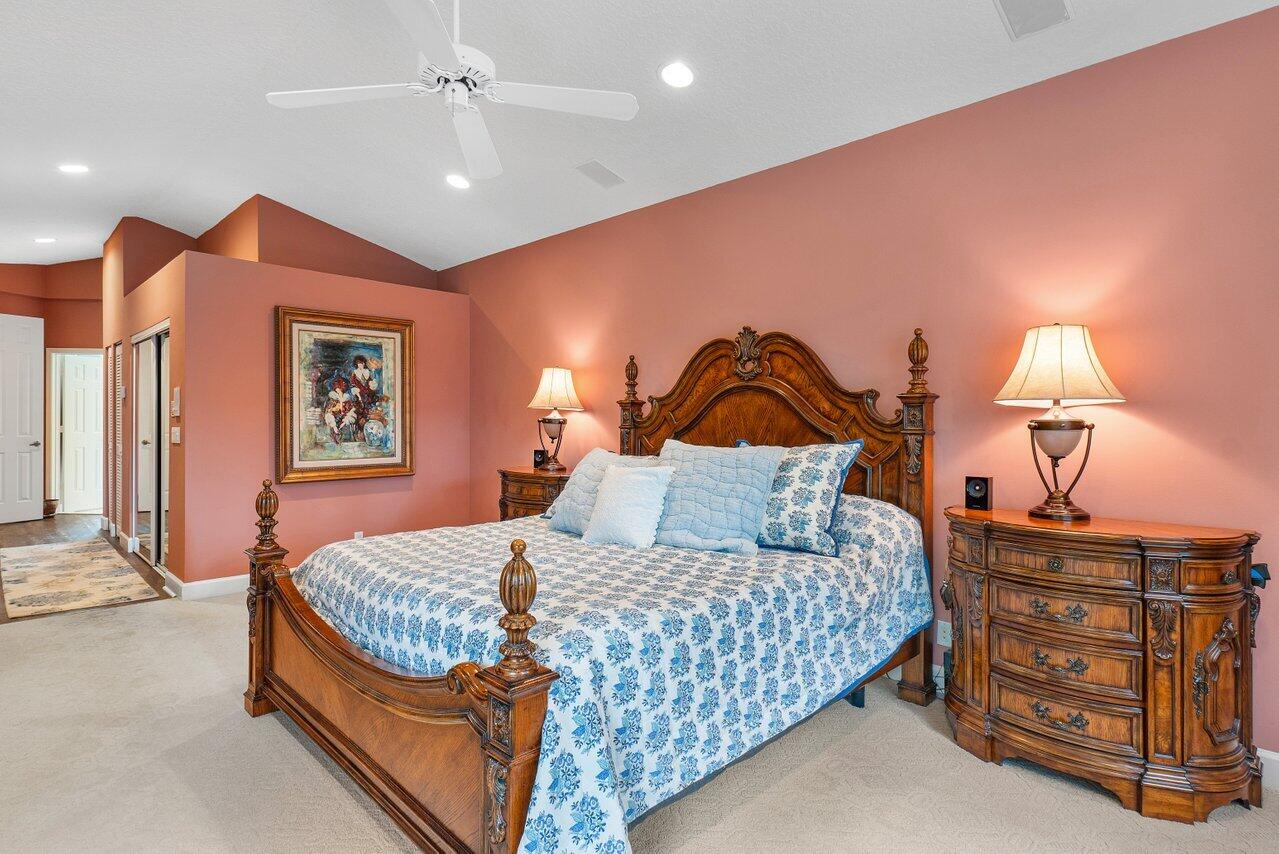9031 Long Lake Palm Drive Boca Raton, FL 33496 - Photo 24 of 53 a bedroom with a bed and dresser with lamp