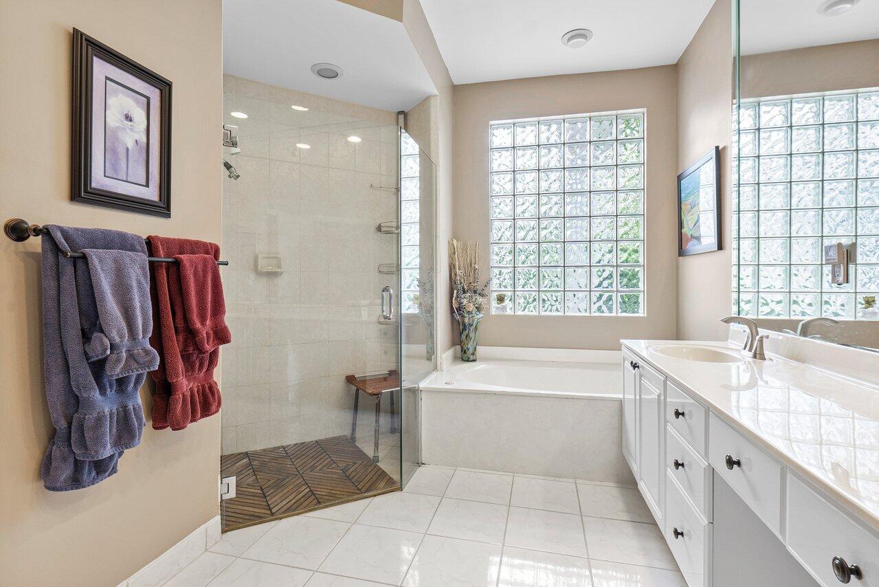 9031 Long Lake Palm Drive Boca Raton, FL 33496 - Photo 27 of 53 a spacious bathroom with a tub sink and shower