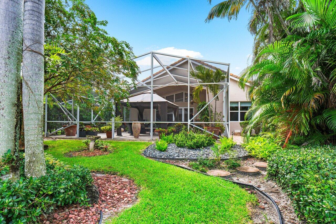 9031 Long Lake Palm Drive Boca Raton, FL 33496 - Photo 31 of 53 a view of a garden with plants and large trees