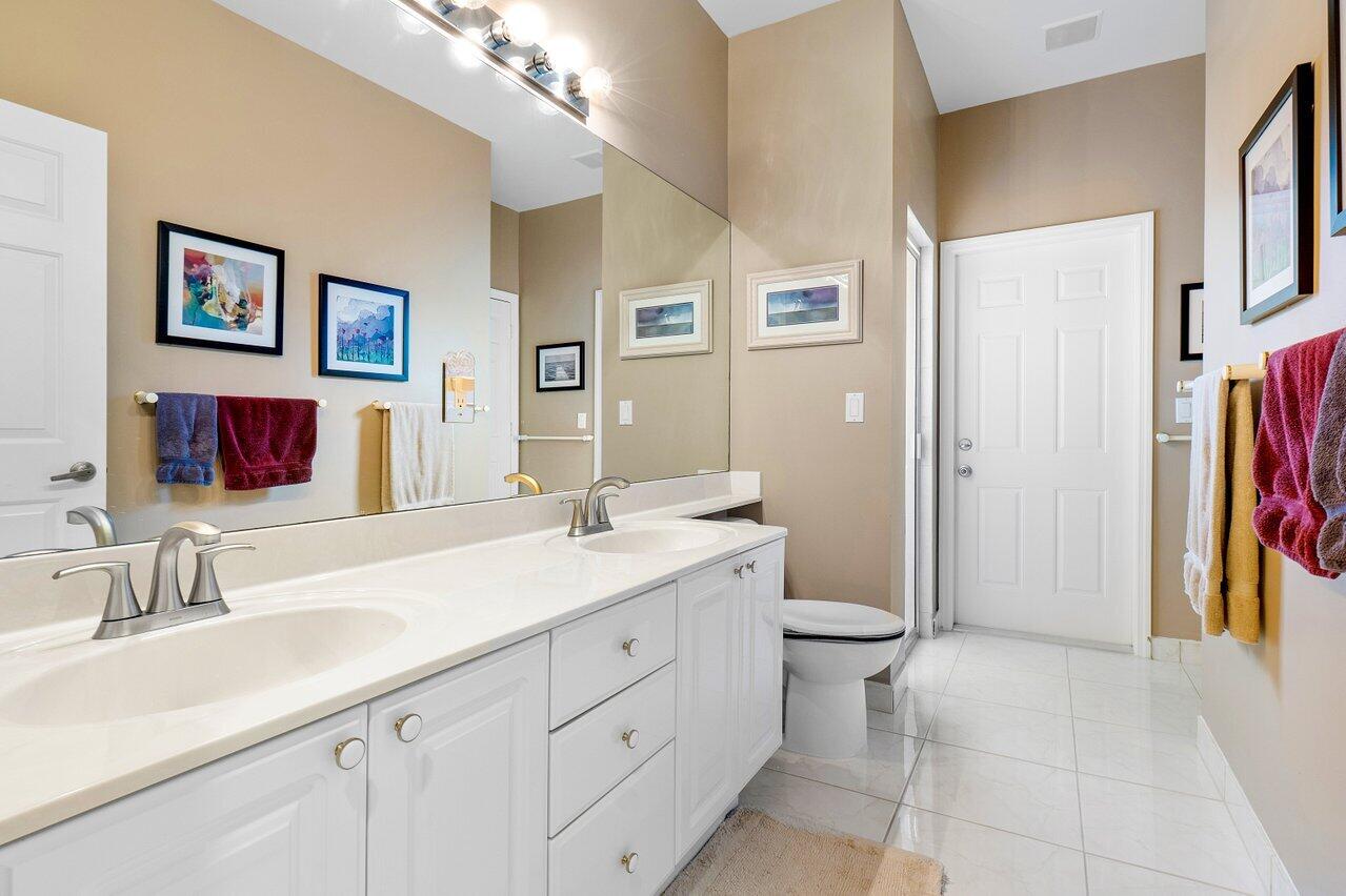 9031 Long Lake Palm Drive Boca Raton, FL 33496 - Photo 38 of 53 a spacious bathroom with a granite countertop sink toilet and shower