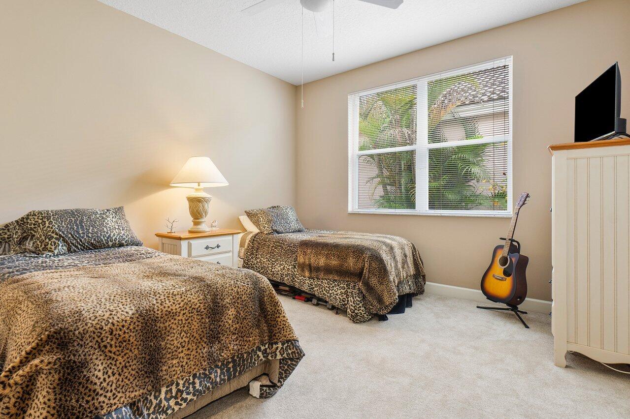 9031 Long Lake Palm Drive Boca Raton, FL 33496 - Photo 41 of 53 a bedroom with two beds and a window