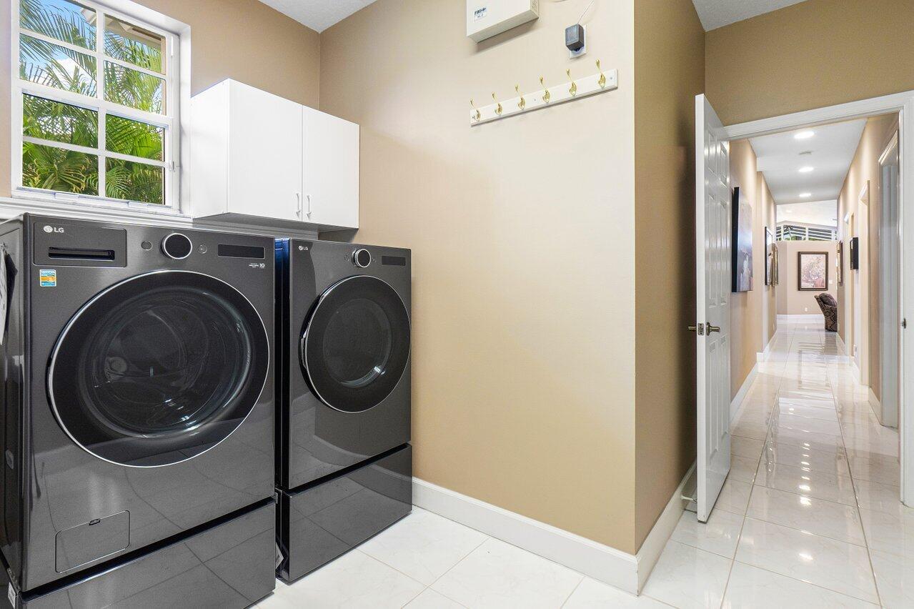 9031 Long Lake Palm Drive Boca Raton, FL 33496 - Photo 42 of 53 a utility room with dryer and washer