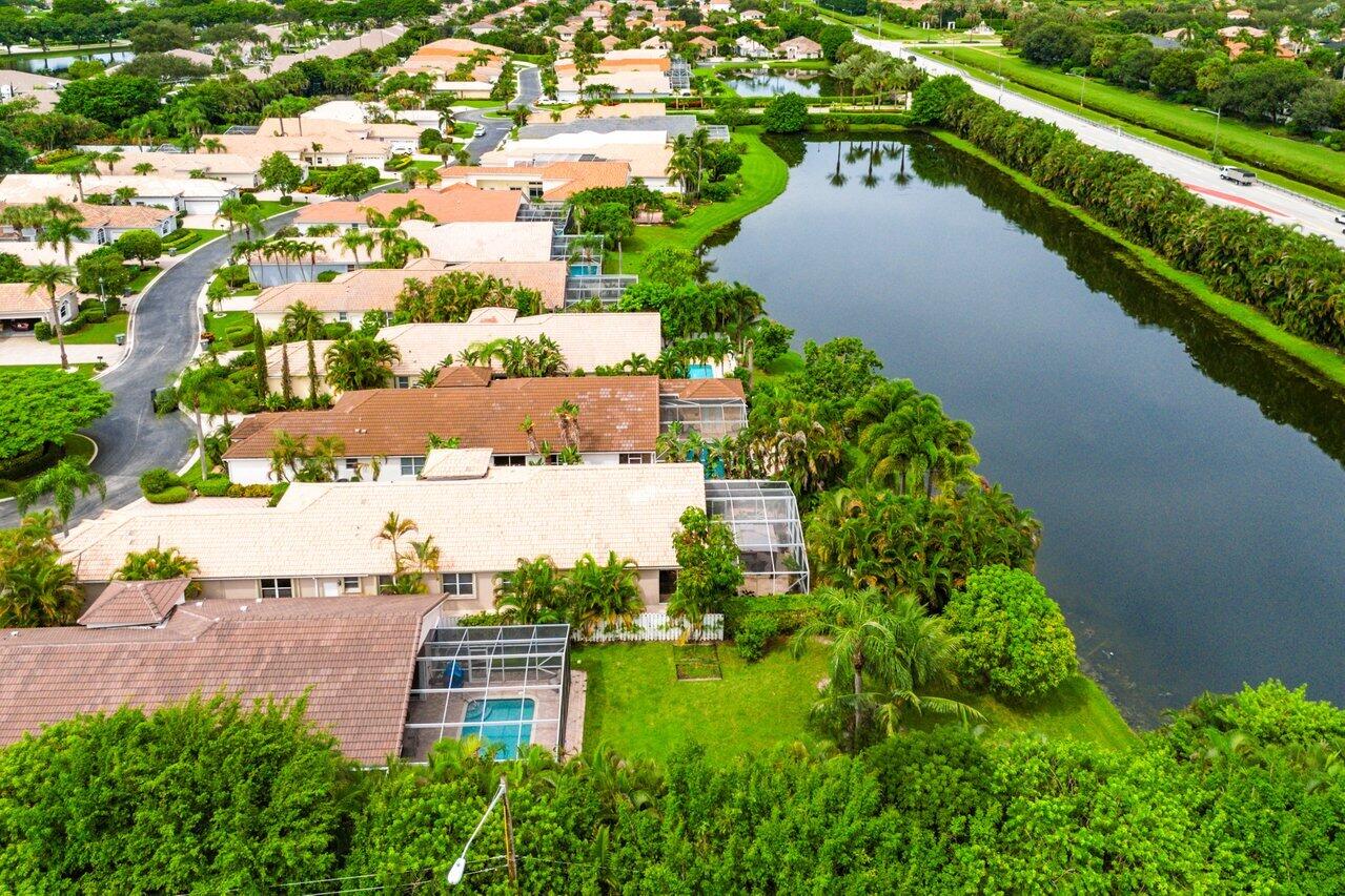 9031 Long Lake Palm Drive Boca Raton, FL 33496 - Photo 46 of 53 an aerial view of a house with a yard and lake view
