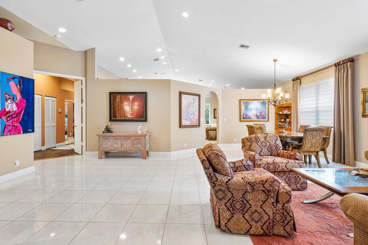 9031 Long Lake Palm Drive Boca Raton, FL 33496 - Photo 8 of 53 a living room with furniture and a flat screen tv