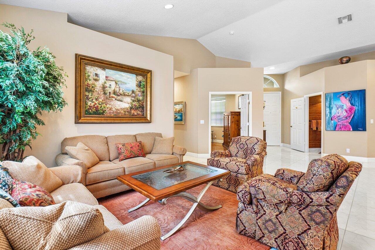 9031 Long Lake Palm Drive Boca Raton, FL 33496 - Photo 9 of 53 a living room with furniture a couch and paintings on the wall