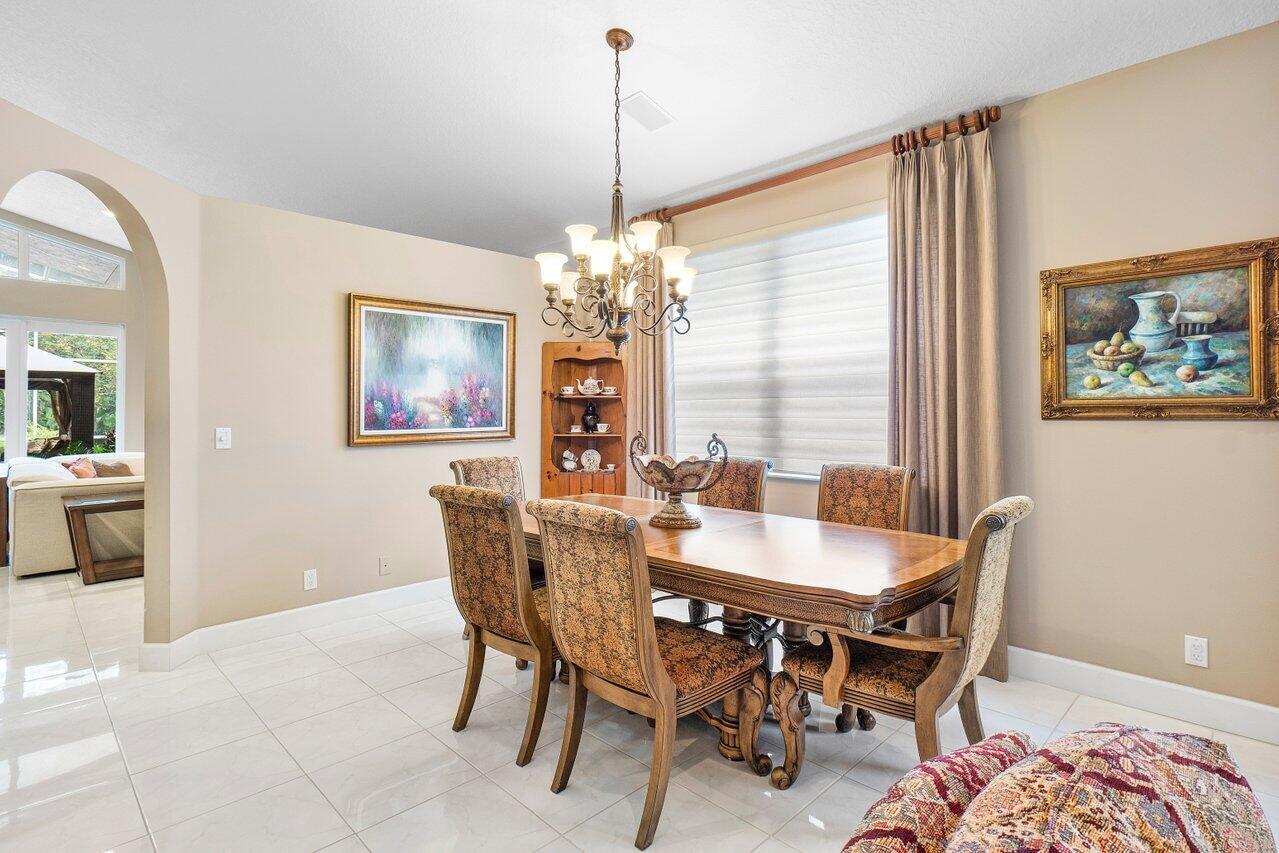 9031 Long Lake Palm Drive Boca Raton, FL 33496 - Photo 10 of 53 a dining room with furniture and window