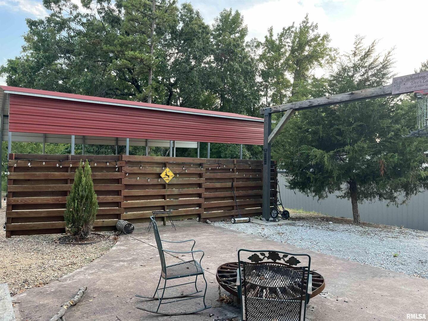5435 Hickory Ridge Road Pomona, IL 62975 - Photo 11 of 67 a view of a patio with table and chairs with wooden floor and fence