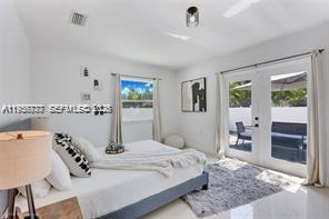 1401 Southwest 3rd Avenue Dania Beach, FL 33004 - Photo 7 of 13 a bedroom with a bed and a large mirror on the dresser