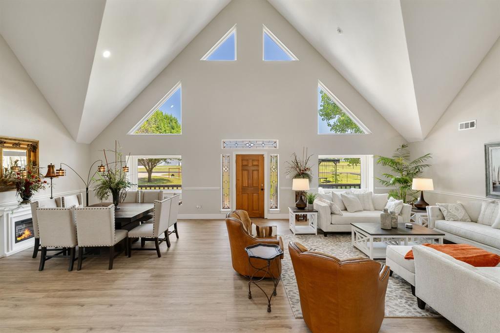 12240 Wellington Road Ponder, TX 76259 - Photo 10 of 40 Vaulted ceilings define this expansive living area, featuring an impressive arrangement of triangular and rectangular windows