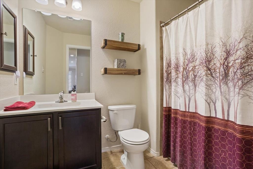 5308 Tama Drive Waco, TX 76708 - Photo 23 of 29 a bathroom with a sink vanity mirror and toilet