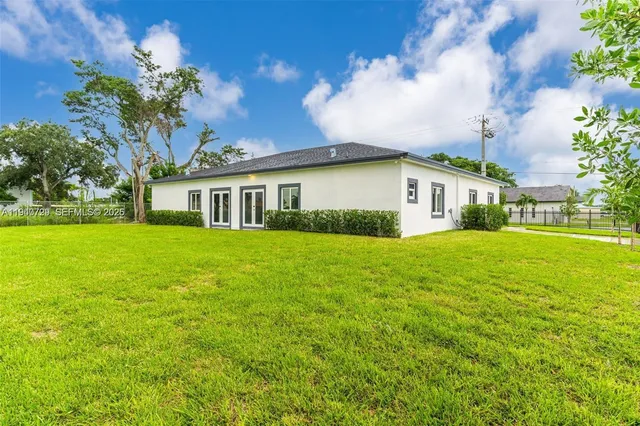 a view of house that has a yard