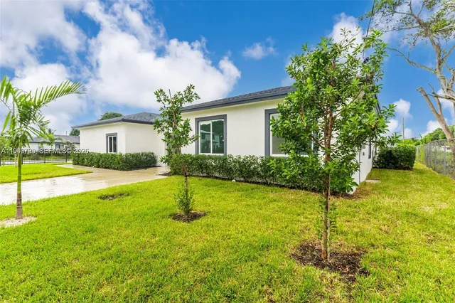 a house view with swimming pool and garden