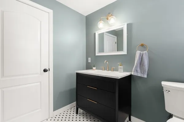 a bathroom with a sink vanity and mirror