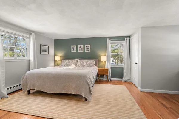 a bedroom with a large bed and a window